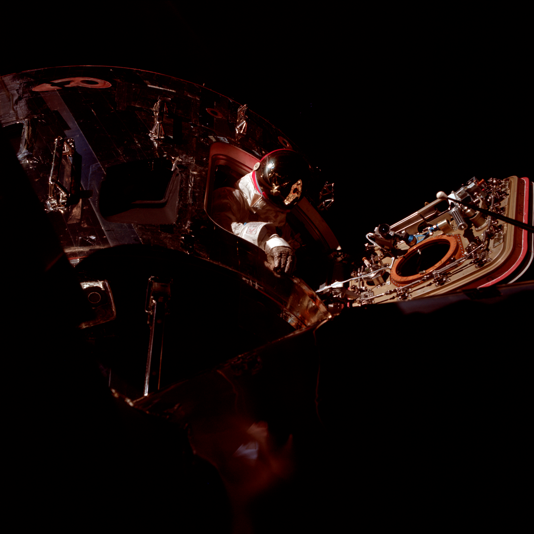 CSM Pilot David Scott floats in the hatchway of the CSM spacecraft Gumdrop during the Apollo 9 spacewalk. AS09-20-3055